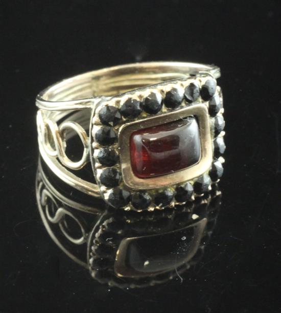 A William IV gold, foil backed garnet? and jet mourning ring, size K.